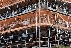 Newly-installed windows surrounded by scaffolding amid extensive renovations on the listed 34-35 Whitefriargate, an art-deco former Burton's store in Kingston upon Hull.