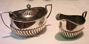 Creamer and sugar bowl from Atchison, Topeka and Santa Fe Railway service, made by Harrison Brothers & Howson [Wikidata] for dining car service ATSF Holloware Dscn0977 crop.jpg