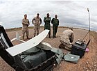 A U.S. Marine, right, with the 24th Marine Expeditionary Unit prepares an RQ-11B Raven unmanned aerial system for a demonstration flight for members of the Royal Moroccan Armed Forces in support of exercise 120411-M-FR139-051.jpg