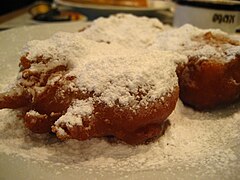 Apple fritter with powdered sugar