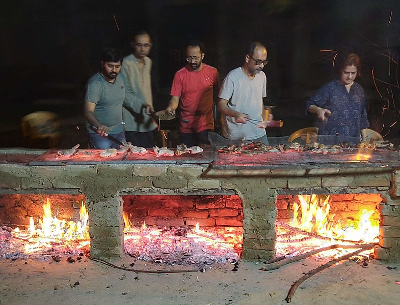 Sen preparing barbecue chicken at Barbecue Festival (Harish-Chandra Research Institute, Feb 2019)
