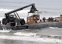 Cargo is unloaded from an improved Navy lighterage system causeway ferry JLOTS