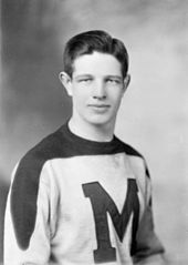 Black and white photo of Bauer in 1944 dressed in a St. Michael's Majors hockey uniform