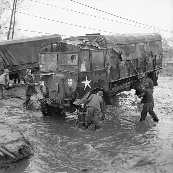 File:Dutch boys help British troops clean an AEC Matador lorry in a village stream, 25 November 1944. B12100.jpg