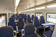 Upper level of a bi-level Bombardier coach. Since this picture was taken, the cloth headrests have been replaced with leather ones and the power outlets have been retrofitted with two 120 V outlets and two USB ports. Frontrunner bombardier car interior.jpg