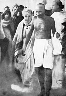 Gandhi with Annie Besant en route to a meeting in Madras in September 1921. Earlier, in Madurai, on 21 September 1921, Gandhi had adopted the loin-cloth for the first time as a symbol of his identification with India's poor. Gandhi besant madras1921.jpg