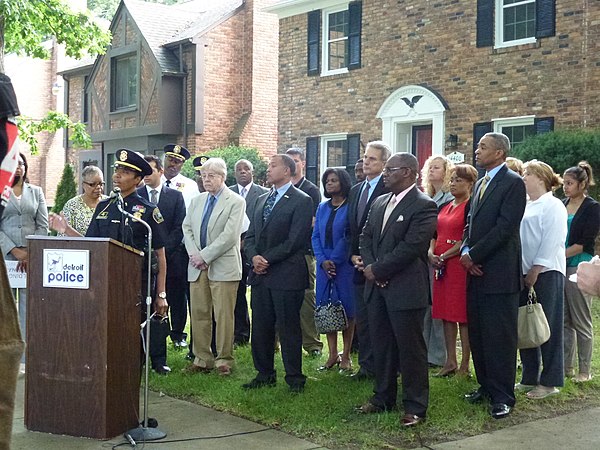 George Kelling stands with leaders of the Detroit Police Department and other local officials at a press conference in 2013. The department partnered 