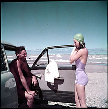 A couple outside on the Lake Huron surf at Grand Bend, July 1951 Grand Bend, Ontario, Canada - 1951.jpg