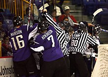 Ice hockey players wearing helmets fighting. Ice hockey players wearing helmet fight.jpg