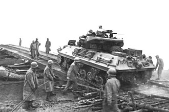 M10 of the 773rd crossing the Saar outside Dillingen. M10 tank destroyer crossing the Saar, December 1944.jpg