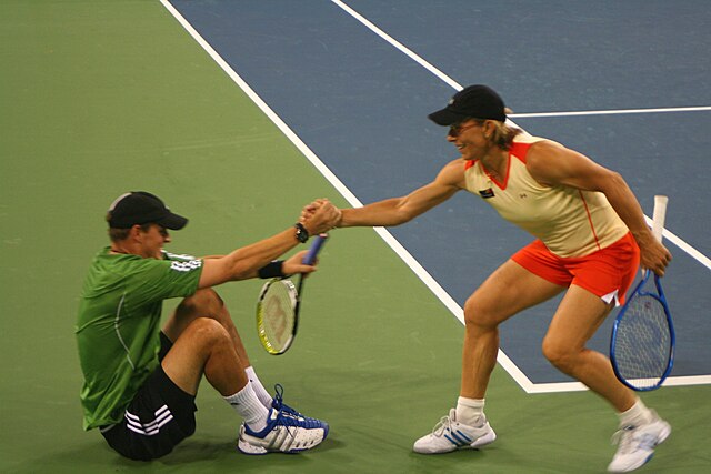 Martina Navratilova gives Bryan a hand. The pair won the 2006 Mixed Doubles title at the US Open.