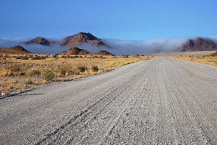Thick morning fog rolls in from the ocean, near Sossusvlei; moisture from the fog allows the native flora to survive the aridity