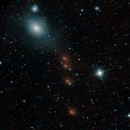 Comet C/2013 A1 Siding Spring multiple exposure – four separate images superimposed against the same background stars (NEOWISE; 28 July 2014). (The four reddish smudges, center; the blue/white ovals top left are galaxies.)