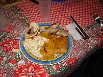 Traditional Christmas meal in Venezuela with pan de jamón and hallacas.