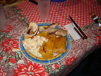 Traditional Christmas meal in Venezuela with pan de jamón and hallacas.