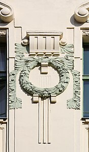 Mix of Art Nouveau and Neoclassicism – Laurel wreath, a motif taken from Greco-Roman antiquity, on a façade of the Czech Technical University (Trojanova no. 11) in Prague, designed by František Schlaffer (1907)