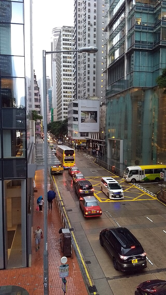 Western end of Queen's Road East on a rainy day, viewed from the overpass. Three Pacific Place is on the right. Hopewell Centre is visible in the distance.