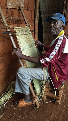 Weaving raffia. Raphia weaver in Babouantou.jpg