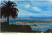 A 1960s era postcard shows Shelter Island (marked by a row of palm trees) jutting out into San Diego Bay Shelter Island & San Diego Bay postcard (1960s-70s).JPG