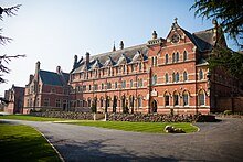 Former Stanbrook Abbey main building in Worcestershire. Entrance to right, sacristy to left, with presbytery in distance. Stanbrook Abbey Exterior.jpg