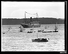 Themistocles off Neutral Bay, New South Wales on 26 January 1933, dressed overall as flagship of the Anniversary Day Regatta THEMISTOCLES moored off Neutral Bay in Sydney for the Anniversary Day Regatta (7404980016).jpg