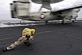US Navy 040714-N-9742R-024 USS Enterprise (CVN 65) Catapult Officer Lt. Pamela Nickrand, from Jacksonville, Fla., ducks down as an E-2C Hawkeye launches off the flight deck.jpg