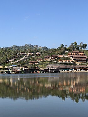 Village of Ban Rak Thai, Thailand on a hill with reflection on the Khuean Nai Mok Reservoir.