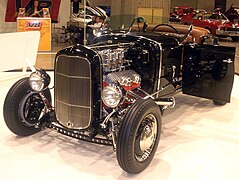 Hot rod with 1931 roadster body and chassis, Deuce grille shell, chrome-hatted carburetors, drilled I-beam dropped front axle, finned drum brakes, and zoomie pipes