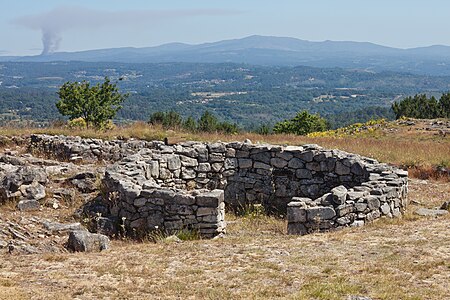 Hill fort of San Cibrao de Las (San Amaro, Galicia, Spain) and a fire with smog in the upper left part of the image.