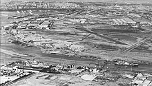 Aerial view of GAF along the Yarra River showing the taxiway between the back of the factory and the Fishermans Bend runway c. 1954