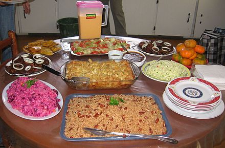 Haitian dishes; rice and beans (diri kole ak pwa), pink salad (with potato and beets), baked macaroni, fried plantains, fried chicken and pork (griot), green salad, sauce and piklis (similar to coleslaw)