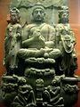 Buddha triad and kneeling Kushan devotee couple. 3rd century.