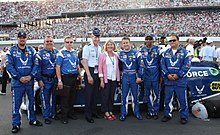 Shiplett (third from left) with his pit crew, his driver A. J. Allmendinger and Chief of Staff of the United States Air Force Norton A. Schwartz and his wife on pit road before the 2011 Coke Zero 400 CSAF, wife meet with NASCAR team 110704-F-GA376-008.jpg