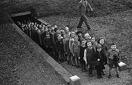 Children outside air raid shelter in Gresford, 1939