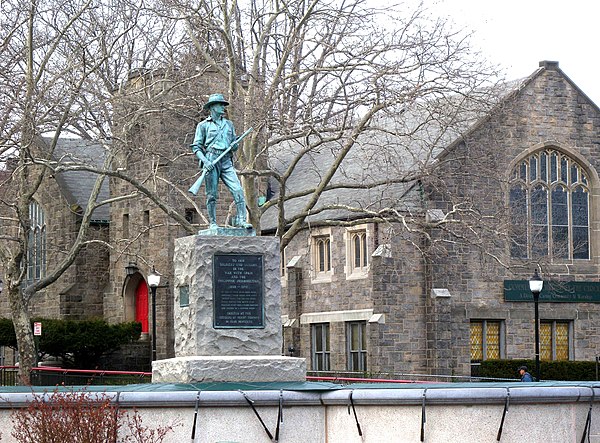 northeast at statue and Community Church of the Circle in Mt. Vernon on a cloudy afternoon