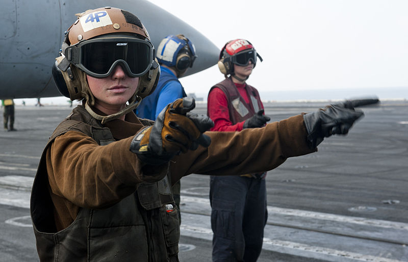 File:Defense.gov News Photo 120109-N-OY799-024 - U.S. Navy Airman Elaine Ketola left signals for the start up of an F A-18C Hornet aircraft from Strike Fighter Squadron 192 on the flight deck of.jpg