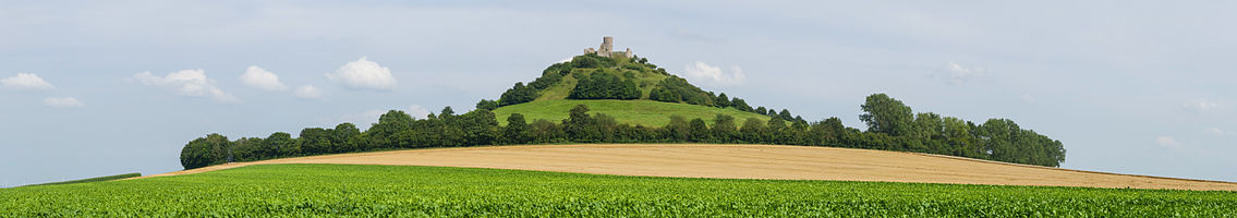 Panoramic view of Desenberg, western view. The hill Desenberg, a former vulcano, near the village Daseburg is located in the area of Höxter in North Rhine-Westphalia. It is the most remarkable landmark of Warburger Börde flatlands. The area around the top has a very special flora and fauna due to its island position.