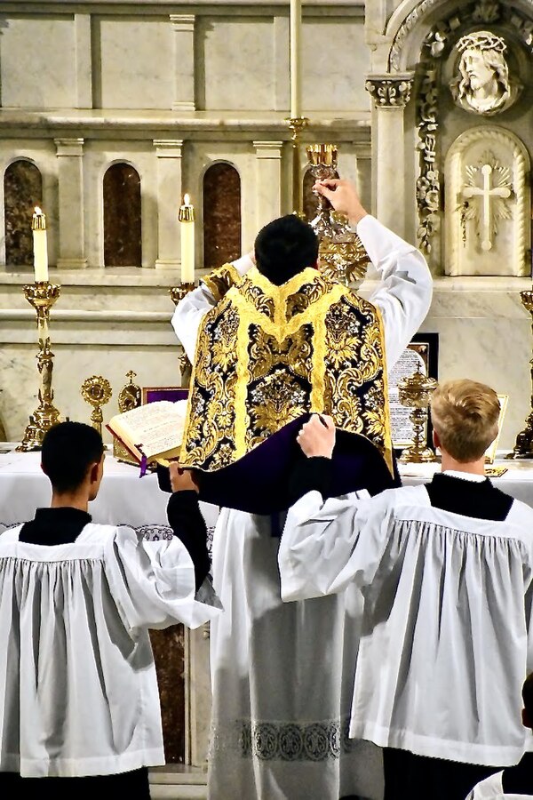 Elevation of the Chalice during consecration at a Missa Cantata