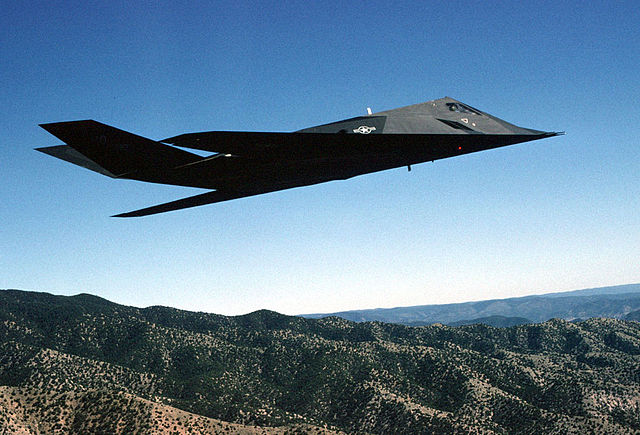An F-117A Nighthawk Stealth fighter from the 49th Fighter Wing, 9th Fighter Squadron "Iron Knights," from Holloman AFB, New Mexico, flies a training m