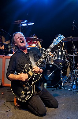 The band was formed and has been led by singer, songwriter and multi-instrumentalist Michael Gira, here shown performing in Kansas City, Missouri in September 2012. Gira (2012-09-19 by Ian T. McFarland).jpg