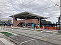 Station entrance and building from Glen Huntly Road and Route 67 tram stop, October 2023