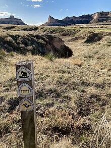 A photo of the former overland trails, with historic trails marker, through Mitchell Pass at Scotts Bluff National Monument. Great platte river road with trails marker.jpg