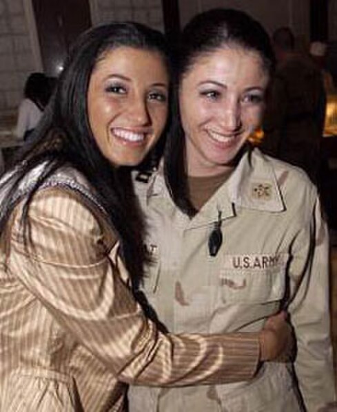 Miss New York USA 2004 Jaclyn Nesheiwat (left) visited U.S. troops in Iraq in March 2004. While in Baghdad, she met her sister, Army Capt. Julie Neshe