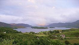 A lake with islands in the middle and hills on either side