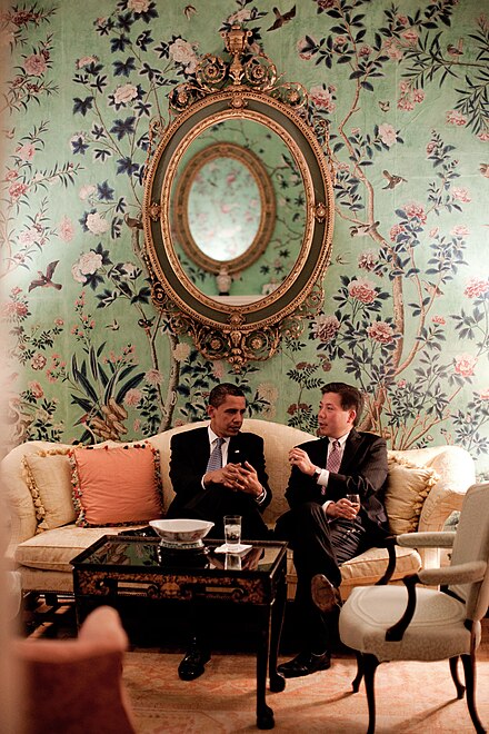 President Obama and Labor Secretary Lu confer together on a Blair House couch in the Dillon Room, 2009. The green hand-painted Chinese wallpaper dates to 1770 and was donated by C. Douglas Dillon in 1964.