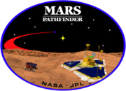 An image inside an oval, depicting two spacecraft, one a lander, and one a rover, on the surface of Mars. The words "Mars Pathfinder" are written on the top and the words "NASA · JPL" are written on the bottom.