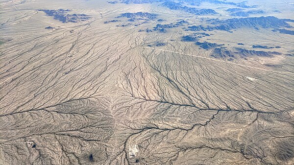 A minor drainage divide south of Buckeye, Arizona. Both branches flow to the Gila River.