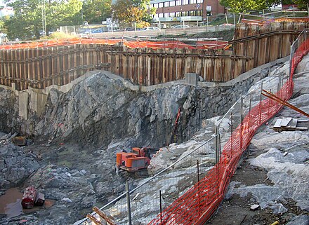 Sheet piles are used to restrain soft soil above the bedrock in this excavation