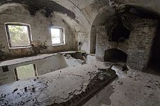 Partly collapsed room with a baker's oven