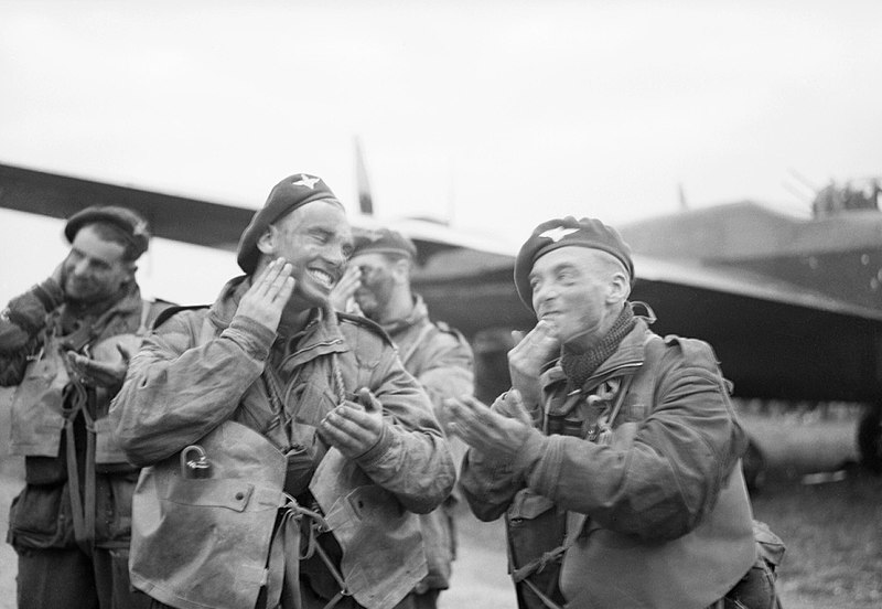 File:Paratroops of 6th Airborne Division blackening their faces in front of an Albemarle aircraft at RAF Harwell, 5 June 1944. H39066.jpg